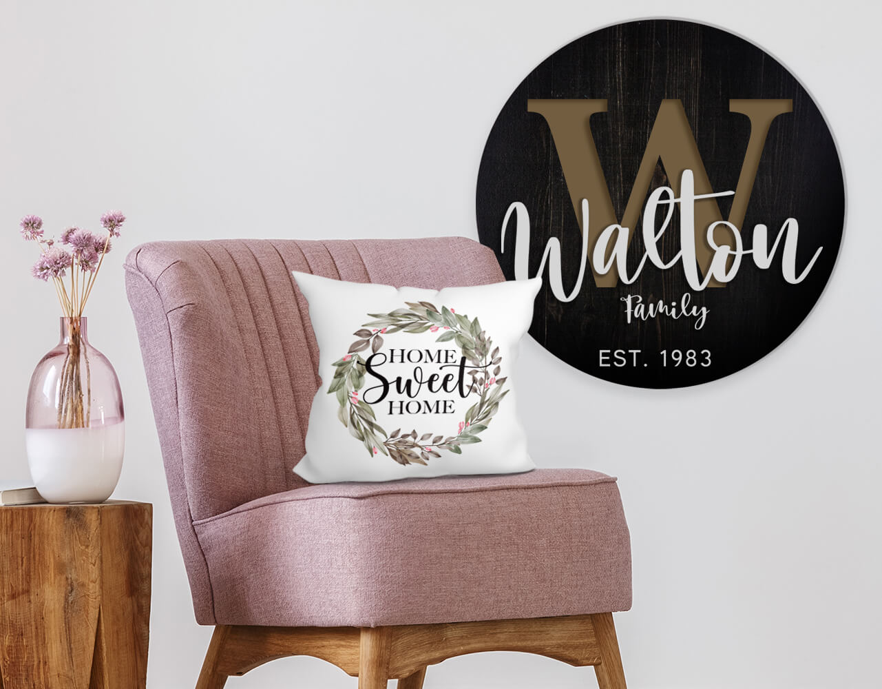 personalized family name wall decor, customized cushion on a chair next to a small table with flowers in a vase